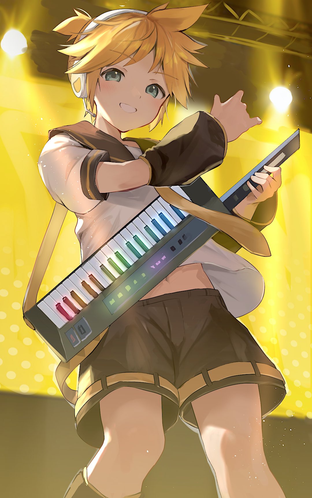 1boy aqua_eyes black_shorts blonde_hair cocolo_(co_co_lo) commentary cowboy from_below headphones highres holding holding_instrument indoors instrument kagamine_len keytar looking_at_viewer male_focus midriff_peek necktie short_ponytail shorts smile solo spotlight standing vocaloid yellow_necktie