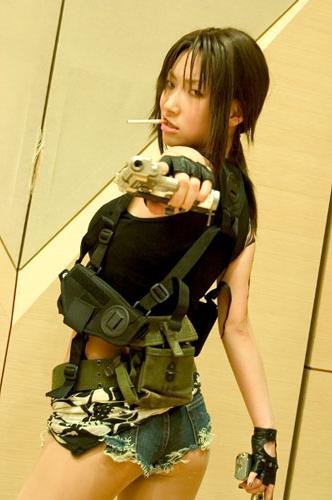 ass beretta_92 black_lagoon cosplay crop_top cutoffs denim denim_shorts dual_wielding fingerless_gloves gloves gun handgun holding holding_gun holding_weapon holster looking_back lowres midriff mouth_hold omi_gibson_(cosplayer) photo pistol revy_(black_lagoon) short_shorts shorts shoulder_holster solo trigger_discipline weapon