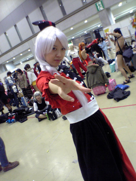cosplay dress dutch_angle looking_at_viewer outstretched_arm photo real_life sash short_sleeves silver_hair touhou yagokoro_eirin