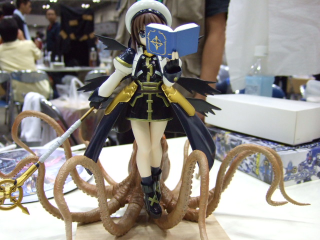 book cropped_jacket figure fingerless_gloves gloves hat jacket lyrical_nanoha magical_girl mahou_shoujo_lyrical_nanoha mahou_shoujo_lyrical_nanoha_a's octopus open_clothes open_jacket photo schwertkreuz solo staff tentacles tome_of_the_night_sky waist_cape yagami_hayate