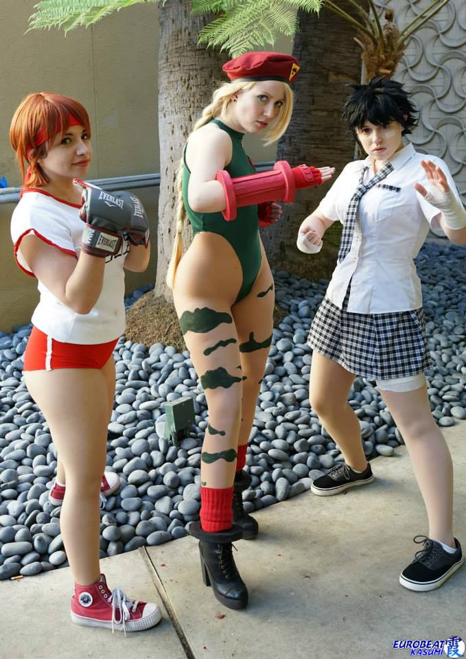 3girls boxing_gloves braid cammy_white cammy_white_(cosplay) capcom cosplay gauntlets gloves ikuy kasugano_sakura kasugano_sakura_(cosplay) leotard makoto makoto_(cosplay) makoto_(street_fighter) makoto_(street_fighter)_(cosplay) multiple_girls necktie open_mouth photo red_hair school_uniform short_hair skirt smile solo sportswear street_fighter thong_leotard tie twin_braids v
