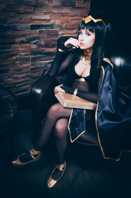 1girl black_hair blunt_bangs bodystocking bodysuit book bra breasts cape circlet cleavage cosplay finger_to_mouth fire_emblem fire_emblem:_kakusei hair_ornament holding_book looking_at_viewer photo sitting solo tharja tharja_(cosplay) twintails