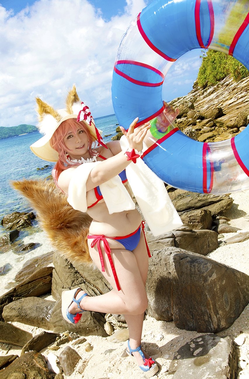 1girl animal_ears asian bikini blue_bikini breasts caster_(fate/extra) chouzuki_maryou cloud cloudy_sky cosplay day ears_through_headwear fake_animal_ears fate/extra fate/grand_order fate_(series) fox_ears fox_tail hat hips innertube large_breasts legs long_hair looking_at_viewer necklace outdoors photo pink_hair shoes side-tie_bikini sky solo standing standing_on_one_leg straw_hat swimsuit tail tamamo_no_mae_(swimsuit_lancer)_(fate) thighs yellow_eyes