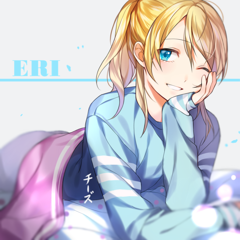 artist_name ayase_eli bad_id bad_pixiv_id bangs bed_sheet blonde_hair blue_eyes blue_shirt character_name chi_zu_crazy chin_rest eyebrows_visible_through_hair grey_pants grin hair_between_eyes long_hair looking_at_viewer love_live! love_live!_school_idol_project lying on_stomach one_eye_closed pants ponytail shirt smile solo swept_bangs under_covers