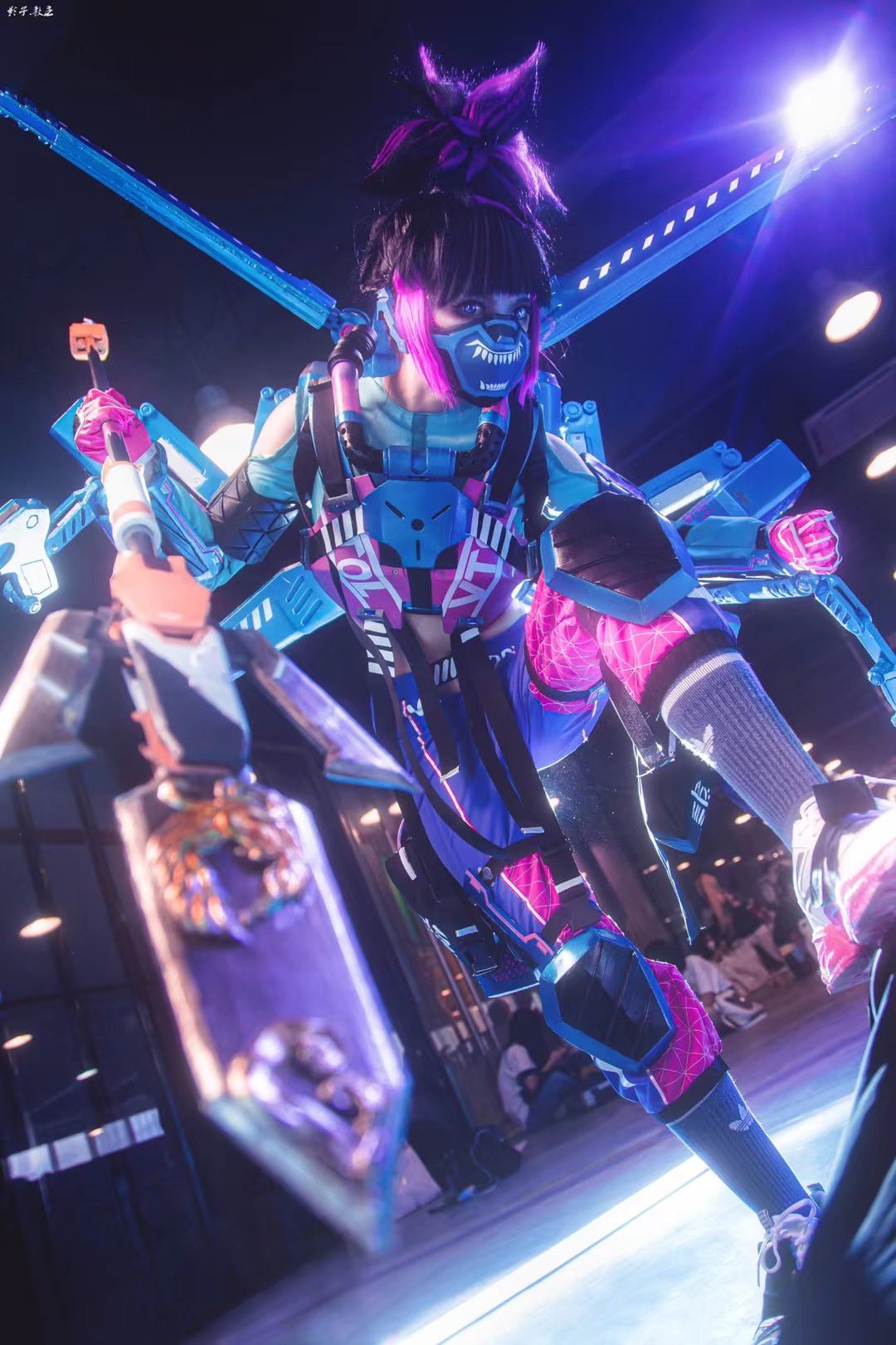 1girl apex_legends armor black_hair blue_shirt breastplate clenched_hand clothing_cutout cosplay_photo di_guan fluorescent_tech_valkyrie gloves grey_socks highres holding holding_polearm holding_weapon knee_pads lance looking_at_viewer mask mouth_mask multicolored_hair photo_(medium) pink_gloves polearm purple_eyes purple_hair shirt shoes shoulder_cutout sneakers socks solo streaked_hair suzaku_(apex_legends) valkyrie_(apex_legends) weapon white_footwear