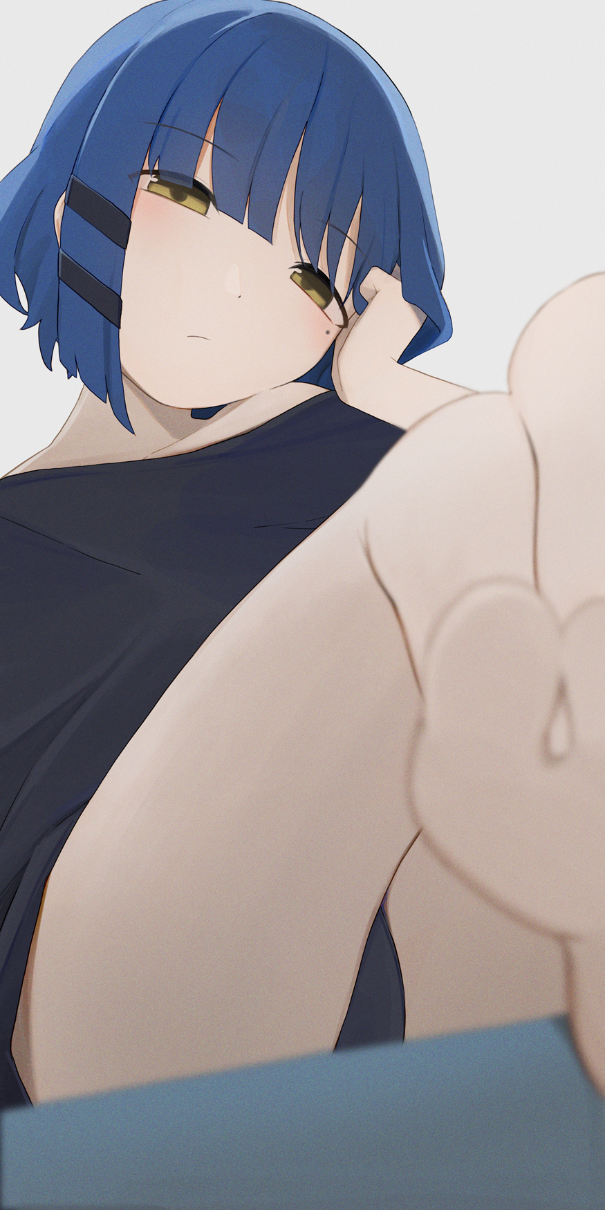 1girl black_shirt blue_hair blurry blurry_foreground blush bocchi_the_rock! closed_mouth commentary grey_background highres hiroki_(yyqw7151) legs looking_at_viewer mole mole_under_eye shirt short_hair simple_background sitting solo thighs toes yamada_ryo yellow_eyes