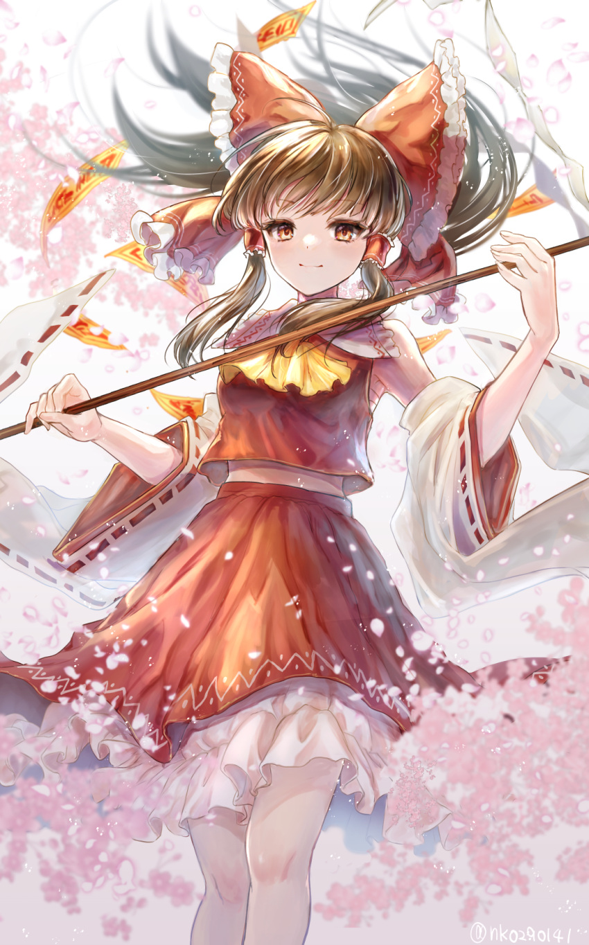 1girl ascot bow brown_hair detached_sleeves frills gohei hair_bow hair_tubes hakurei_reimu highres holding long_hair long_sleeves looking_at_viewer natsume_k petticoat red_bow red_shirt red_skirt ribbon-trimmed_sleeves ribbon_trim shirt sidelocks skirt skirt_set smile solo touhou wide_sleeves