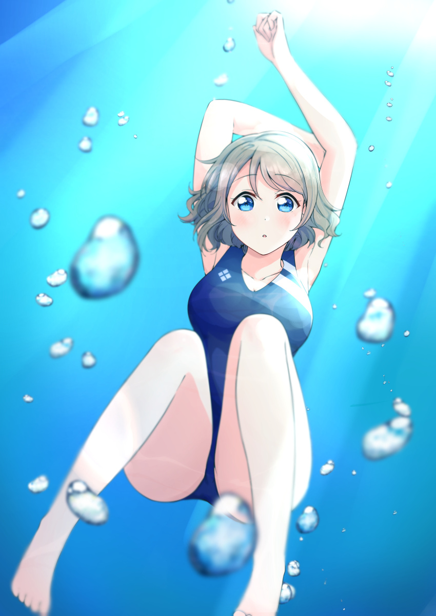 1girl :o absurdres air_bubble arm_up blue_eyes blue_swimsuit blue_theme breasts brown_hair bubble cleavage competition_swimsuit eyebrows_visible_through_hair freediving full_body grey_hair hair_between_eyes highres holding_breath light_rays love_live! love_live!_sunshine!! medium_breasts ocean one-piece_swimsuit outdoors satisfaction-zero short_hair solo stretch submerged sunlight swimming swimsuit underwater watanabe_you water