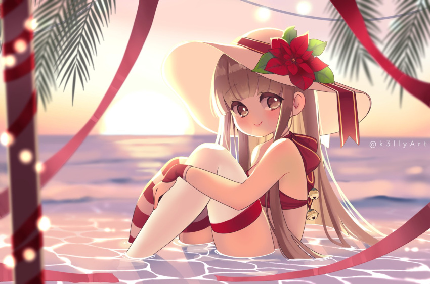 1girl angelica_(k3lly) bell bikini blunt_bangs brown_eyes brown_hair english_commentary flower gloves hand_on_own_knee hat hat_flower highres jingle_bell k3lly light_blush long_hair looking_at_viewer original outdoors red_bikini red_flower red_gloves red_ribbon ribbon sitting smile solo striped_clothes striped_thighhighs sun swimsuit thighhighs twitter_username water white_hat white_thighhighs
