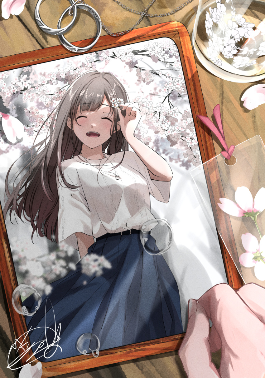 1girl ^_^ arm_at_side blue_skirt blurry brown_hair bubble cherry_blossoms chiyoda_sakura closed_eyes depth_of_field flower glass hand_in_own_hair highres jewelry light_blush long_hair long_skirt necklace open_mouth original outdoors pebble photo_(object) picture_frame pink_flower ring sakura_(nagatoro) shirt short_sleeves signature skirt smile solo soragane_(banisinngurei) spring_(season) standing table teeth upper_teeth_only white_shirt white_tree wooden_table