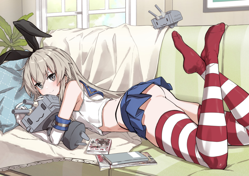 1girl :3 ass black_hairband blue_skirt blush closed_mouth commentary_request couch elbow_gloves gloves grey_eyes grey_hair hairband indoors kantai_collection long_hair looking_at_viewer lying on_couch on_stomach rensouhou-chan shimakaze_(kancolle) shiny shiny_hair skirt smile solo striped striped_thighhighs takanashi_kei_(hitsujikan) thighhighs white_gloves window