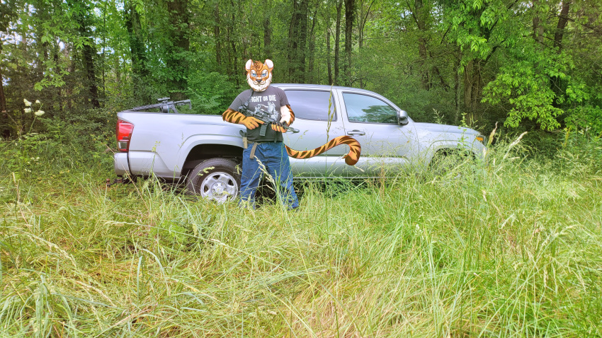 amantiium_glitch anthro ar-15 edit felid glock_17 gun hi_res looking_at_viewer male mammal pantherine photo_manipulation photomorph ranged_weapon tiger truck_(vehicle) vehicle weapon