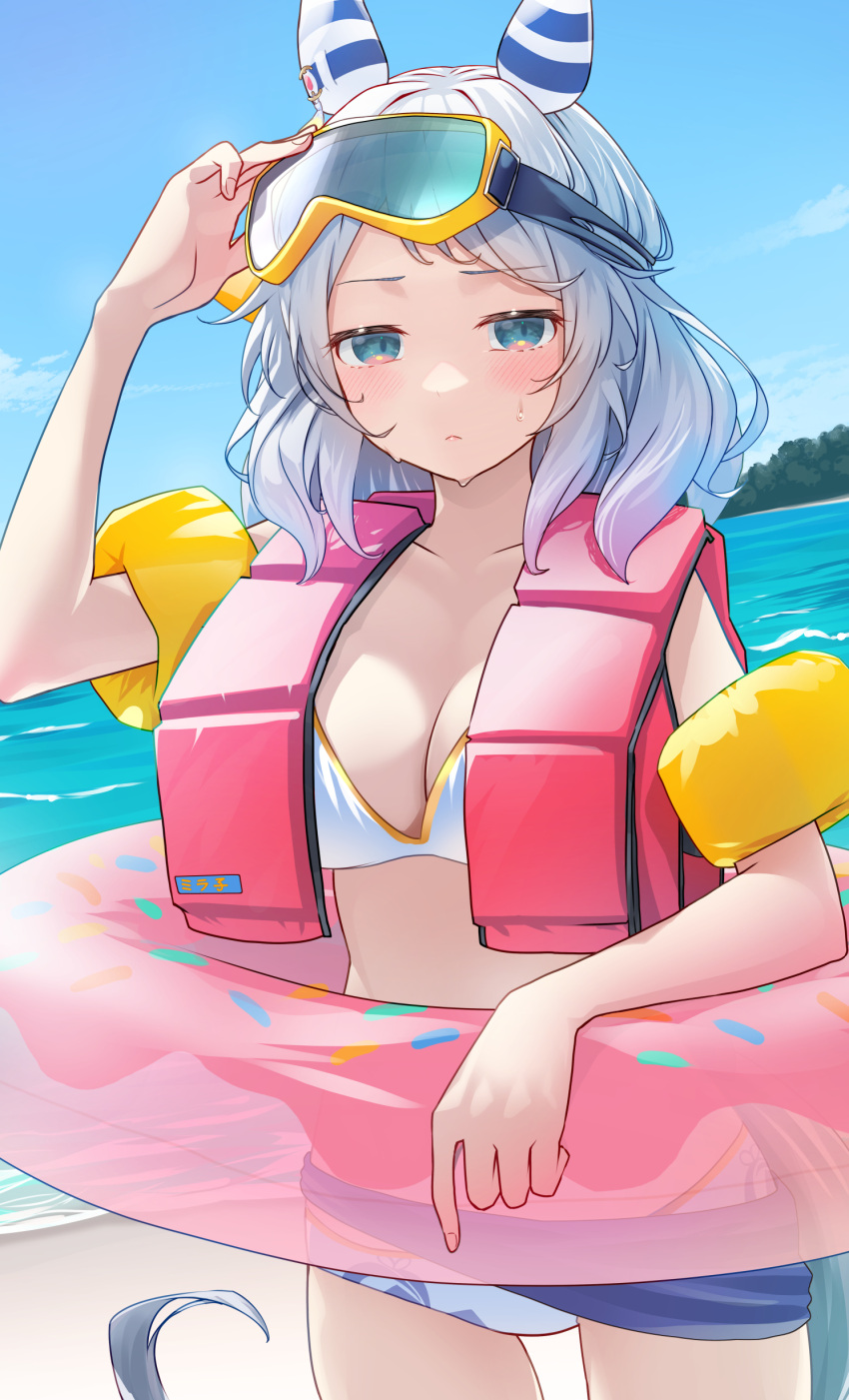 1girl absurdres alternate_costume animal_ears beach bikini breasts cleavage closed_mouth commentary cowboy_shot ear_covers goggles grey_eyes grey_hair highres hishi_miracle_(umamusume) horse_ears horse_girl horse_tail inflatable_armbands innertube life_vest looking_at_viewer medium_breasts medium_hair nabe_puyo ocean outdoors pink_innertube sand solo swimsuit tail umamusume water white_bikini