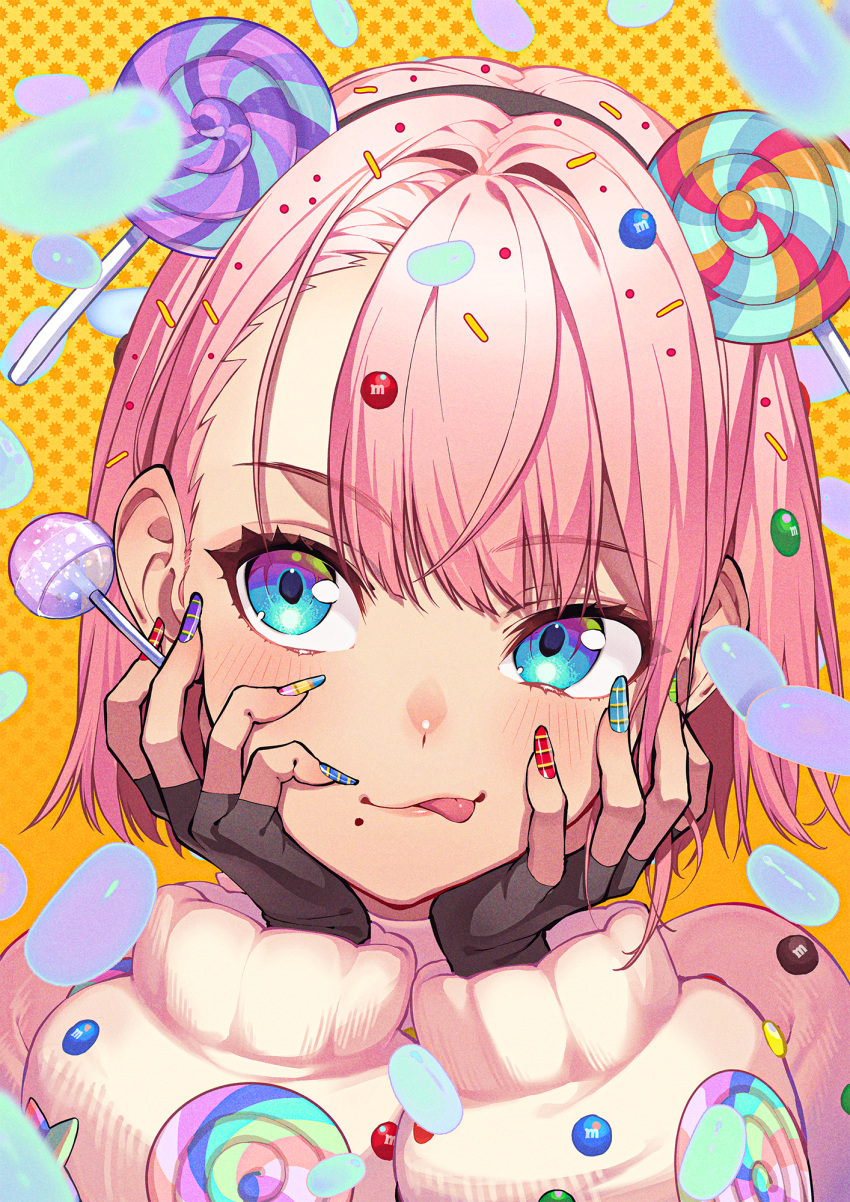 1girl black_gloves blue_eyes blue_nails blush candy fingernails food food-themed_hair_ornament gloves green_nails hair_ornament hands_on_own_face highres kabu_(niniko2ko) lollipop long_sleeves m&amp;m's mole mole_under_mouth multicolored_nails nail_polish original pink_hair portrait purple_nails red_nails solo tongue tongue_out yellow_nails