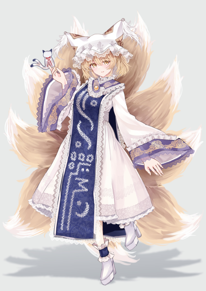 1girl animal_ears blonde_hair blush boots closed_mouth dress fox_ears fox_tail full_body grey_background hat high_heel_boots high_heels highres long_sleeves mob_cap multiple_tails sarasadou_dan shikigami short_hair simple_background smile solo tabard tail touhou white_dress white_footwear white_headwear wide_sleeves yakumo_ran yellow_eyes
