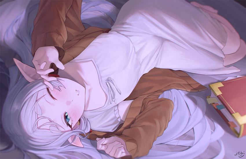 1girl aqua_eyes barefoot bed book bookmark brown_shirt dress elf frieren highres jebi long_hair looking_at_viewer lying on_side one_eye_closed parted_lips pointy_ears shirt sidelocks sousou_no_frieren thick_eyebrows waking_up white_dress white_hair