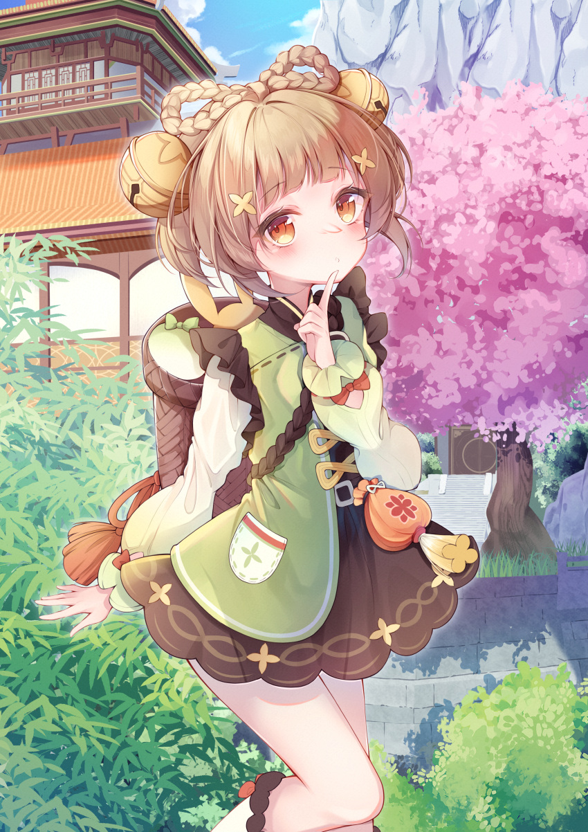1girl absurdres arm_up basket bell blue_sky blunt_bangs blush bow-shaped_hair braid brown_eyes brown_hair cherry_blossoms cloud clover_print day dress eyebrows_hidden_by_hair finger_to_mouth genshin_impact hair_bell hair_ornament hat highres jingle_bell long_sleeves looking_at_viewer nayuuchan outdoors pocket qing_guanmao short_hair sidelocks sky temple turnip yaoyao_(genshin_impact)