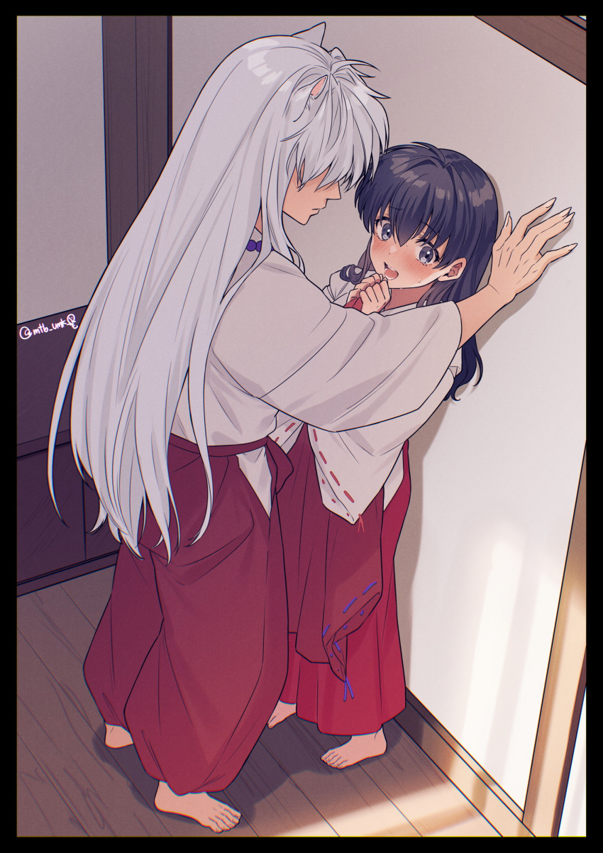 1boy 1girl animal_ears bare_shoulders bead_necklace beads black_hair blush commentary demon_boy dog_boy dog_ears from_above hair_between_eyes hair_over_eyes hakama hetero highres higurashi_kagome indoors inuyasha inuyasha_(character) japanese_clothes jewelry kabedon long_hair long_sleeves miko motobi_(mtb_umk) necklace open_mouth own_hands_together red_hakama red_skirt shirt skirt sweatdrop symbol-only_commentary twitter_username white_hair white_shirt wide_sleeves