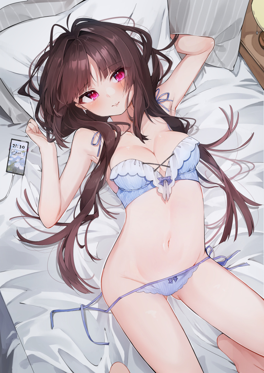 1girl absurdres barefoot bed_sheet blue_bra blue_panties blush bra breasts brown_hair cellphone cleavage closed_mouth commentary_request eme_(emeralda) facing_viewer hands_up highres indoors long_hair looking_ahead lying medium_breasts on_back on_bed original panties phone pillow pink_eyes smartphone solo stomach underwear underwear_only