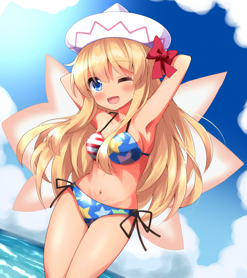 1girl ;d american_flag_bikini armpits arms_behind_back arms_up bikini blonde_hair blue_eyes blush bow cloud commentary_request flag_print highres horizon lily_white long_hair looking_at_viewer navel ocean one_eye_closed open_mouth outdoors red_bow ruu_(tksymkw) smile solo swimsuit tan touhou white_headwear