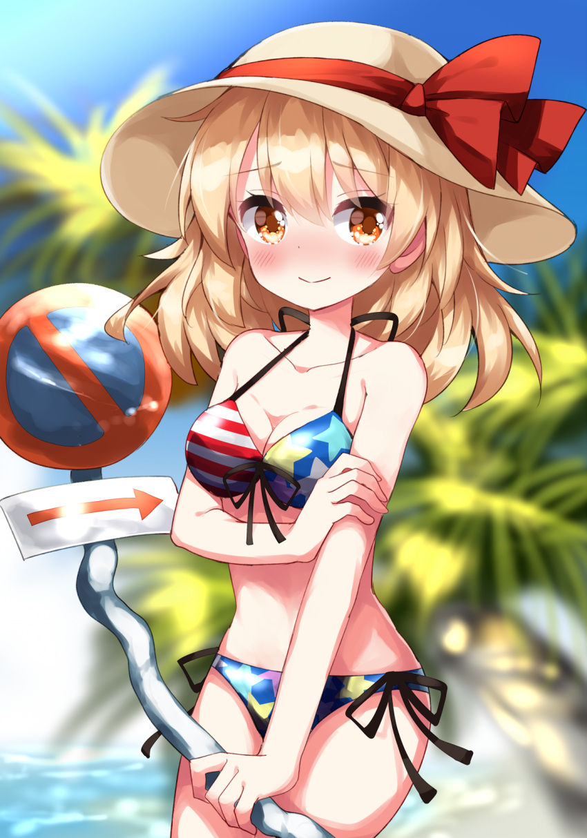 1girl american_flag_bikini bikini blonde_hair blush breasts cleavage closed_mouth commentary_request flag_print hat hat_ribbon highres holding_own_arm kana_anaberal looking_at_viewer medium_breasts medium_hair orange_eyes palm_tree red_ribbon ribbon road_sign ruu_(tksymkw) sign smile solo star_(symbol) star_print swimsuit touhou touhou_(pc-98) tree