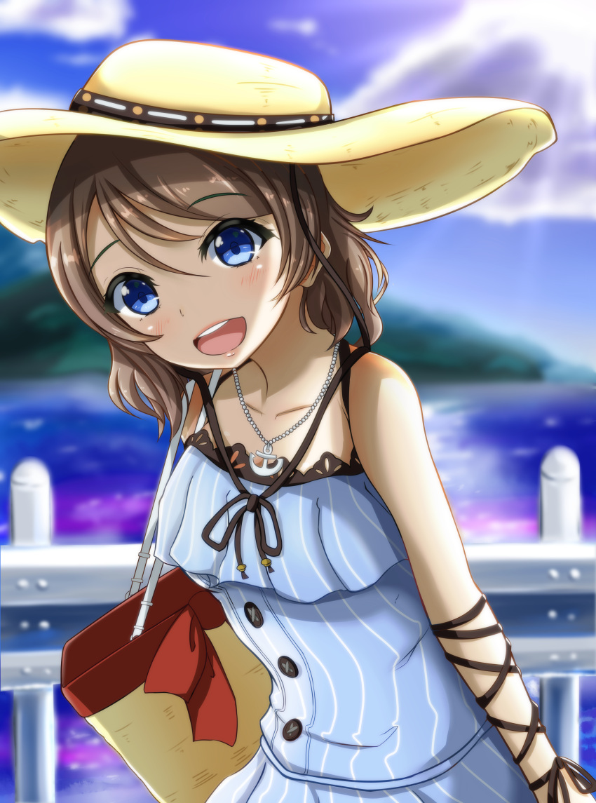 1girl absurdres anchor_symbol bag blue_eyes blush brown_hair fence hat highres jewelry love_live! love_live!_sunshine!! nanao_(m44132yf) necklace ocean short_hair smile solo sun watanabe_you water