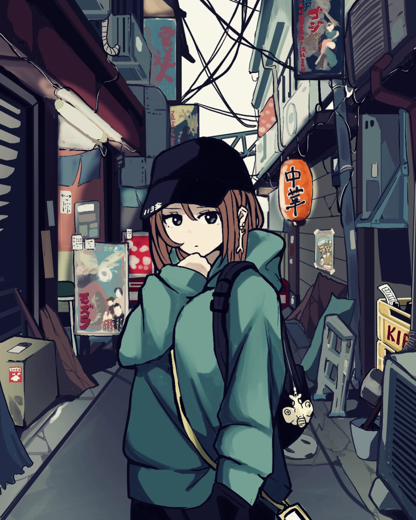 1girl bag bag_charm black_bag black_hat brown_hair charm_(object) earrings godzilla_(series) green_hoodie highres hood hoodie itochin_d jewelry looking_at_viewer medium_hair original outdoors road road_sign shoulder_bag sign solo standing street utility_pole