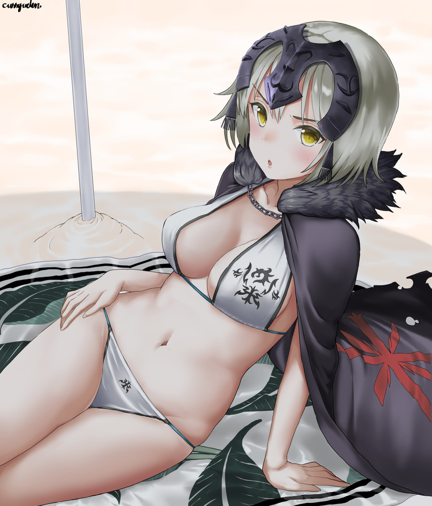 :o arm_support artist_name beach beach_towel bikini blush breasts cape chain cleavage curry_soba day fate/apocrypha fate/grand_order fate_(series) fur_trim headphones highres jeanne_d'arc_(alter)_(fate) jeanne_d'arc_(fate)_(all) looking_at_viewer medium_breasts navel reclining shadow short_hair signature silver_hair sitting solo swimsuit towel white_bikini yellow_eyes