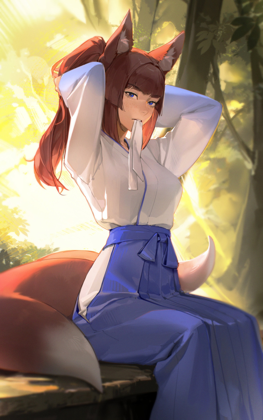 1girl absurdres animal_ear_fluff animal_ears arms_up backlighting blue_eyes blue_skirt blunt_bangs blurry brown_hair commentary day depth_of_field eyelashes feet_out_of_frame fox_ears fox_girl fox_tail freckles hakama hakama_skirt hands_in_hair highres hip_vent japanese_clothes kimono limart long_hair long_sleeves looking_at_viewer miko mouth_hold original pleated_skirt ponytail ribbon ribbon_in_mouth sidelocks sitting skirt solo symbol-only_commentary tail tree tying_hair vegetation white_kimono wide_sleeves