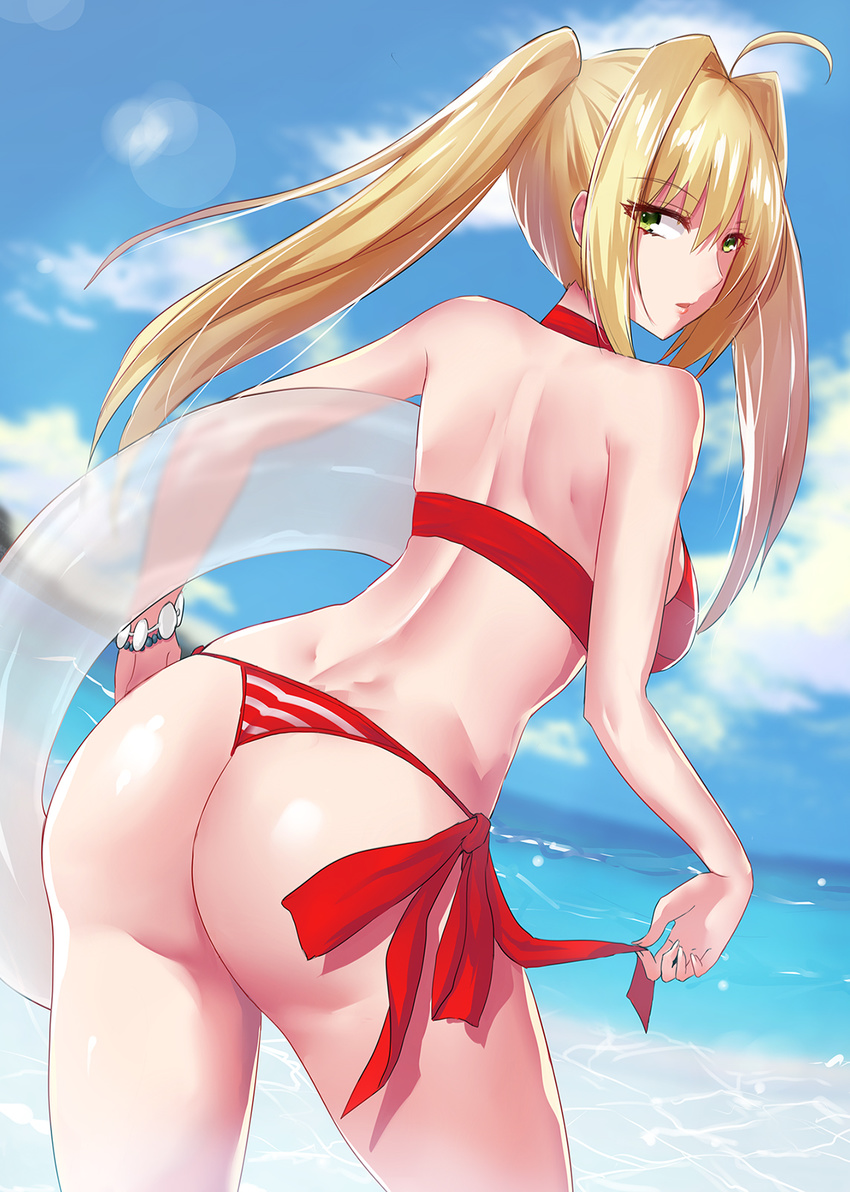 ahoge ass back beach bikini blonde_hair breasts cloud day dimples_of_venus fate/grand_order fate_(series) from_behind green_eyes hair_intakes halterneck highres innertube large_breasts lens_flare long_hair looking_at_viewer looking_back nero_claudius_(fate)_(all) nero_claudius_(swimsuit_caster)_(fate) outdoors rafu_(motrer1) side-tie_bikini sky solo striped striped_bikini swimsuit thong twintails