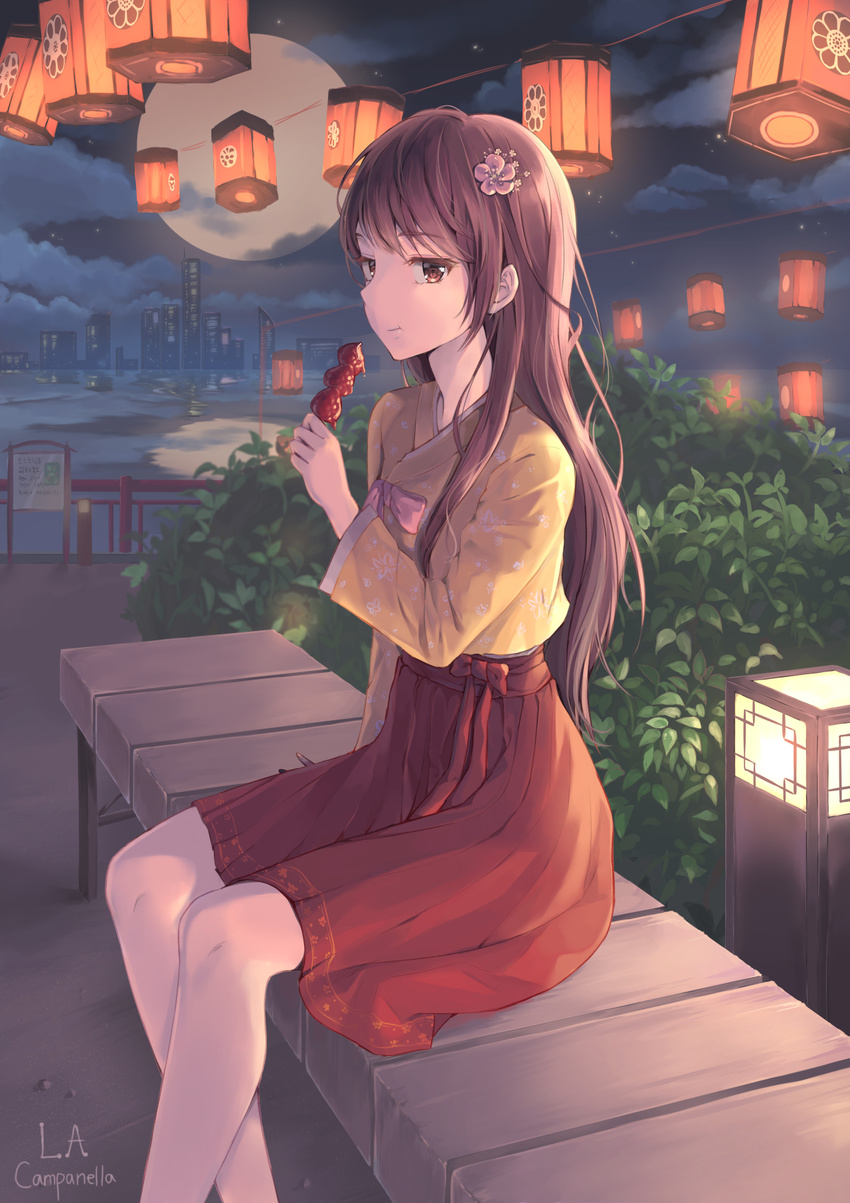 artist_name bangs brown_eyes brown_hair closed_mouth commentary_request eating flower food from_side hair_flower hair_ornament hakama highres holding holding_food japanese_clothes la_campanella lantern long_hair long_sleeves looking_at_viewer night original outdoors red_hakama sitting solo
