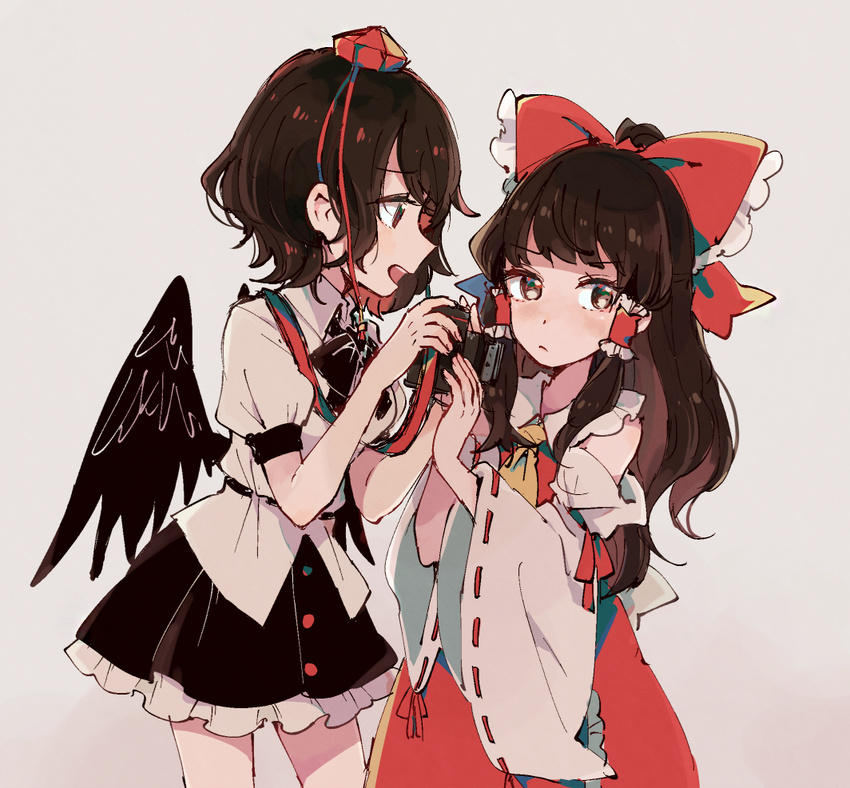 black_hair black_wings brown_eyes brown_hair camera detached_sleeves grey_background hair_ribbon hair_tubes hakurei_reimu hat long_hair mozukuzu_(manukedori) multiple_girls neck_ribbon necktie nontraditional_miko ribbon shameimaru_aya short_hair skirt tokin_hat touhou wide_sleeves wings