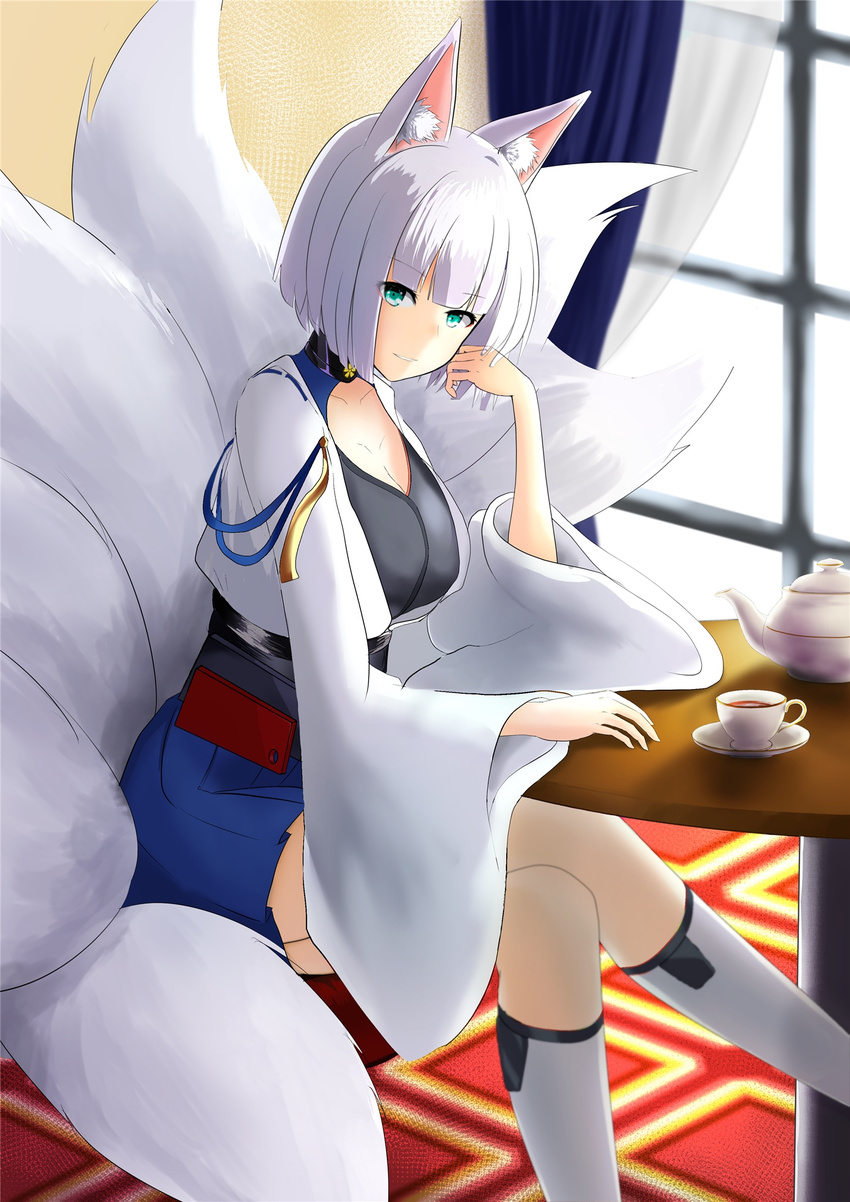 animal_ears azur_lane blue_eyes breasts cleavage commentary_request crossed_legs cup fox_ears fox_tail hakama_skirt highres japanese_clothes kaga_(azur_lane) large_breasts long_sleeves looking_at_viewer multiple_tails parted_lips short_hair sitting smile solo tail tea teacup white_hair wide_sleeves yuto_(adopeko)