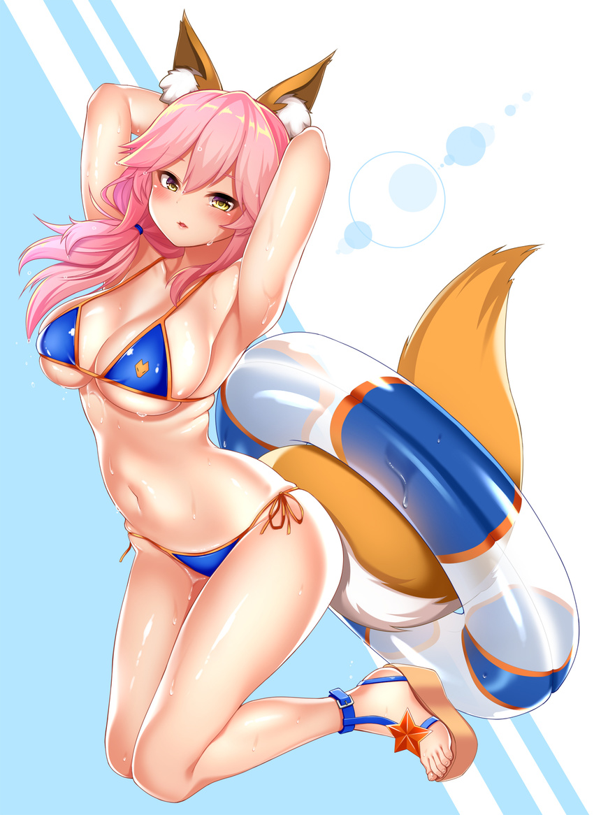 animal_ears armpits arms_behind_back arms_behind_head bikini blue_bikini blush breasts cleavage collarbone commentary_request fate/grand_order fate_(series) fox_ears fox_tail groin highres innertube kashima_mashino large_breasts long_hair looking_at_viewer navel parted_lips pink_hair sandals shiny shiny_skin side-tie_bikini skindentation solo sweat swimsuit tail tamamo_(fate)_(all) tamamo_no_mae_(swimsuit_lancer)_(fate) yellow_eyes
