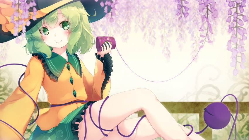 beige_background black_hat blurry blush bow commentary_request cup depth_of_field eyebrows_visible_through_hair feet_out_of_frame floral_print flower frilled_shirt_collar frills gengetsu_chihiro green_eyes green_hair green_skirt hat hat_bow head_tilt highres holding holding_cup komeiji_koishi long_sleeves looking_at_viewer miniskirt purple_flower shirt sitting skirt smile solo string string_phone third_eye touhou wide_sleeves wisteria yellow_bow yellow_shirt