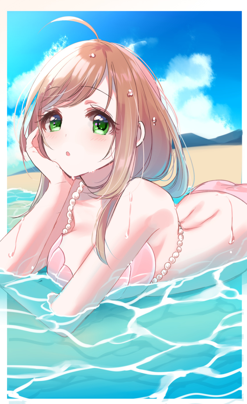 :o ahoge ass bare_arms bare_shoulders beach bikini blue_sky blush breasts brown_hair cloud day eyebrows_visible_through_hair green_eyes hand_on_own_cheek head_rest highres idolmaster idolmaster_cinderella_girls large_breasts long_hair looking_at_viewer lying misumi_(macaroni) ocean on_stomach outdoors partially_submerged pink_bikini sand satou_shin sky solo swimsuit water wet