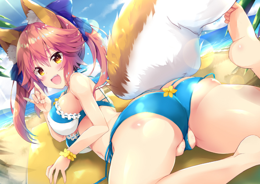 animal_ear_fluff animal_ears ass beach bikini blue_bikini blue_ribbon blush breasts cleavage commentary_request day fang fate/grand_order fate_(series) fox_ears fox_shadow_puppet fox_tail hair_ribbon large_breasts looking_at_viewer looking_back lying maruchan. navel ocean on_stomach open_mouth outdoors palm_leaf palm_tree pink_hair ribbon solo swimsuit tail tamamo_(fate)_(all) tamamo_no_mae_(fate) tree yellow_eyes