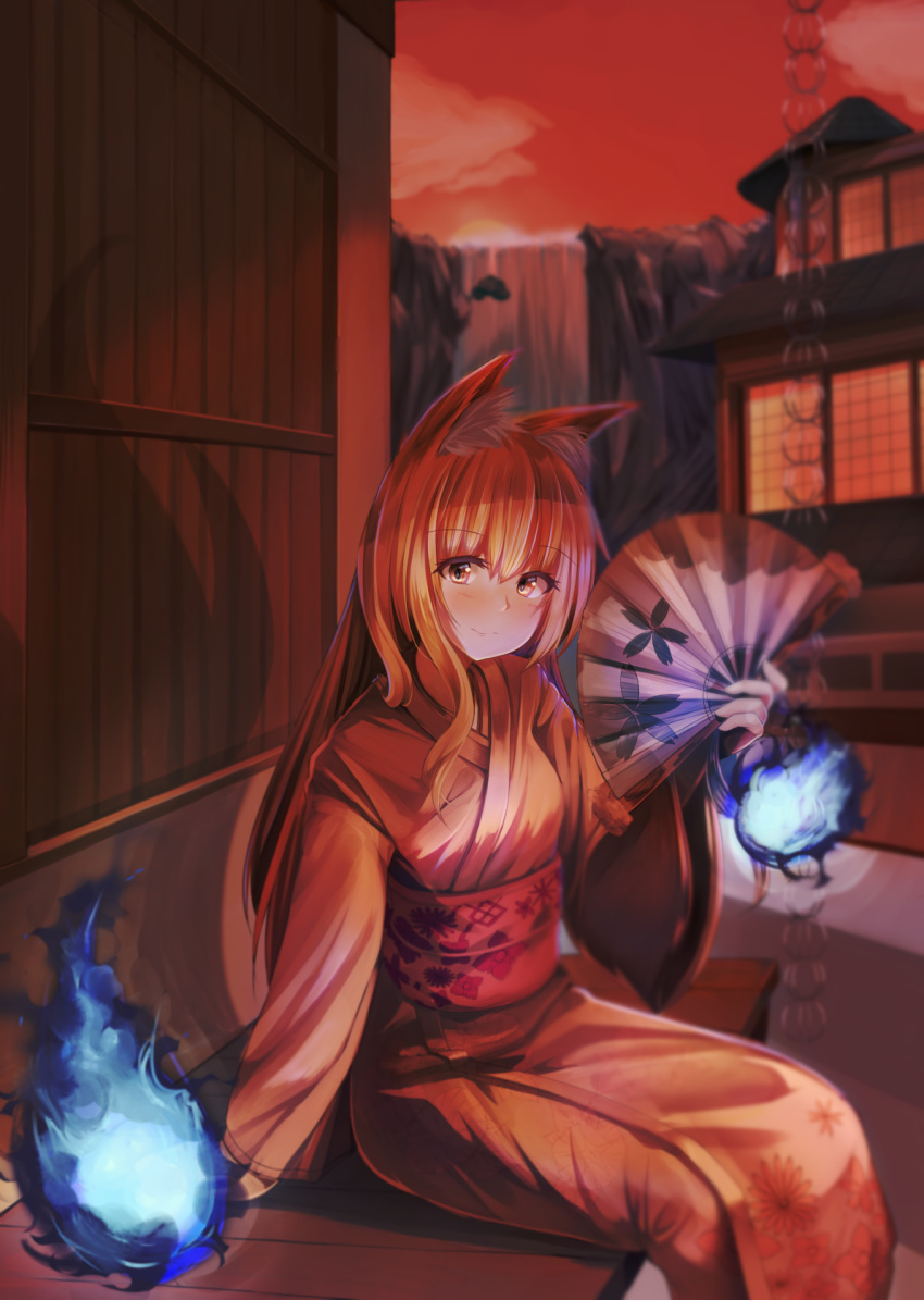 animal_ears blue_fire blush commentary_request evening eyebrows_visible_through_hair fan fire floral_print fox_ears fox_girl highres holding holding_fan japanese_clothes kimono long_hair long_sleeves looking_at_viewer mayama_yakuaji obi orange_sky original paper_fan red_eyes red_hair sash sitting sky solo water waterfall wide_sleeves yukata