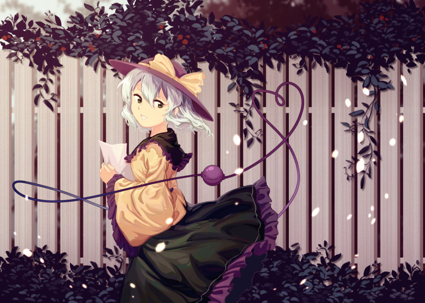 blurry blurry_background bow dress fence furahata_gen green_eyes green_hair hat hat_bow highres holding holding_paper komeiji_koishi leaf light_particles long_sleeves one_eye_closed paper short_hair smile solo third_eye touhou wide_sleeves yellow_bow
