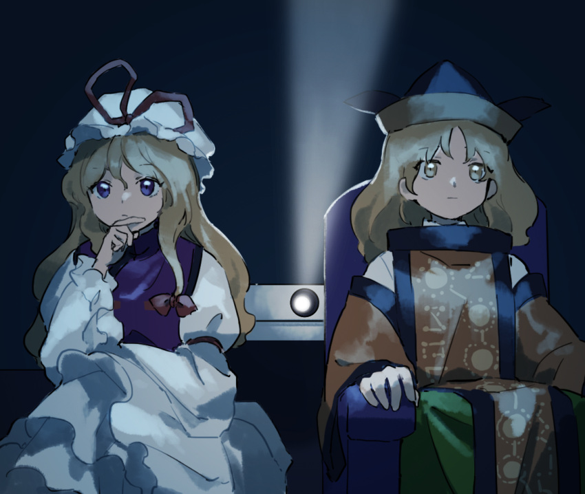 2girls black_headwear blonde_hair closed_mouth constellation_print dress frilled_sleeves frills green_skirt hat hat_ribbon kaigen_1025 long_hair long_sleeves matara_okina mob_cap multiple_girls orange_sleeves projector purple_eyes red_ribbon ribbon sitting skirt tabard touhou white_dress white_headwear wide_sleeves yakumo_yukari yellow_eyes