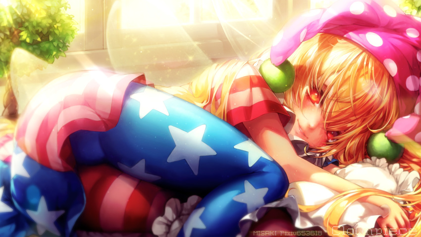 1girl american_flag_dress american_flag_legwear artist_name ass bangs blonde_hair blue_dress blue_legwear blush character_name clownpiece commentary_request dress feet_out_of_frame frilled_pillow frills hair_between_eyes hat highres indoors jester_cap light_particles light_rays long_hair looking_at_viewer lying misaki_(kyal_001) neck_ruff on_side pantyhose parted_lips pillow plant polka_dot polka_dot_hat purple_headwear red_dress red_eyes red_legwear short_dress short_sleeves smile solo star star_print striped striped_dress striped_legwear thighs touhou white_dress white_legwear window