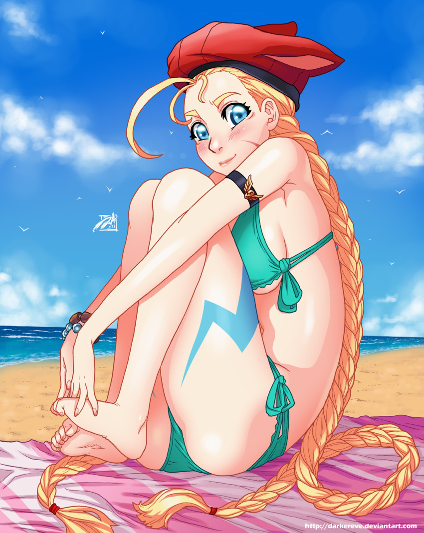 1girl adapted_costume ahoge animal_ears animal_hat beach_towel beret bikini blonde_hair blue_eyes blue_sky bodypaint bracelet braid breasts cammy_white cat_hat commentary darwin_nunez day english_commentary full_body green_bikini hat highres huge_ahoge jewelry knees_on_chest long_braid long_hair looking_at_viewer medium_breasts ocean outdoors sideboob sitting sky solo street_fighter swimsuit thighs toe_scrunch toes towel twin_braids underboob very_long_hair watermark web_address