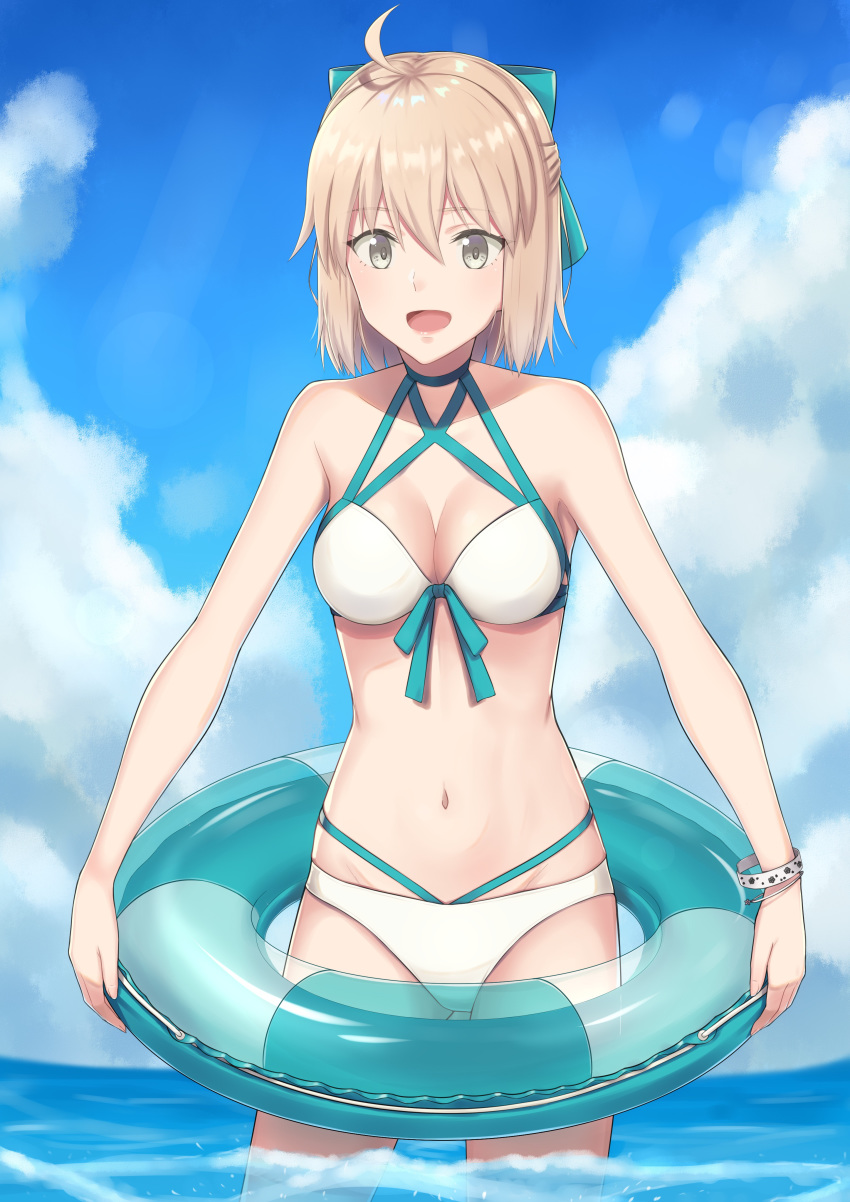 1girl :d absurdres ahoge bangs bikini blonde_hair blue_bow blue_ribbon blue_sky bow breasts cleavage cloud cowboy_shot day eyebrows_visible_through_hair fate_(series) groin hair_between_eyes hair_bow highres innertube k-ya. koha-ace medium_breasts multi-strapped_bikini navel ocean okita_souji_(fate)_(all) okita_souji_(swimsuit_assassin)_(fate) open_mouth outdoors ribbon shiny shiny_hair short_hair sky smile solo standing swimsuit wading white_bikini yellow_eyes