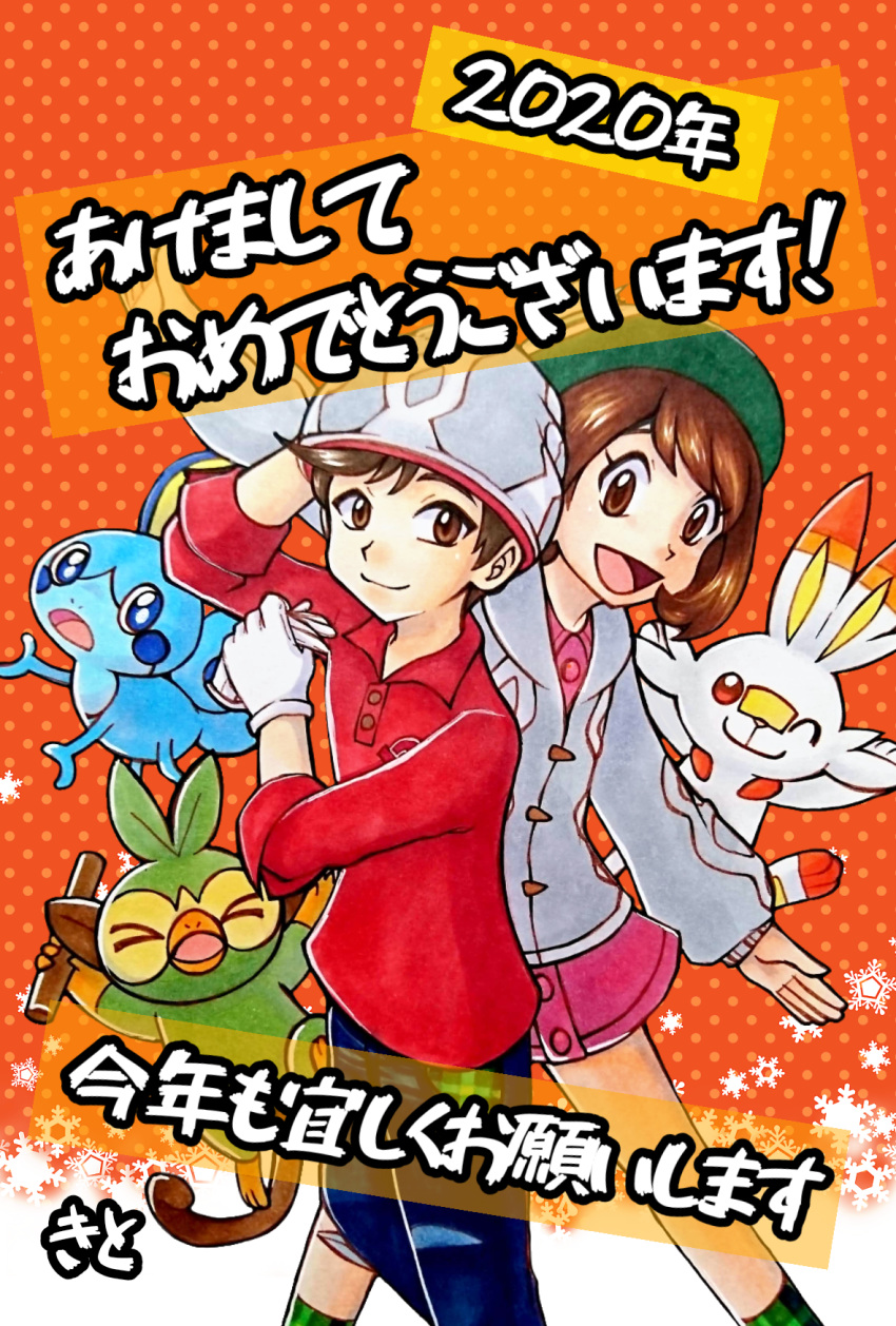 &gt;_&lt; 1boy 1girl 2020 :d blue_eyes brown_eyes commentary_request creature dress gen_8_pokemon green_headwear grookey hapy_new_year highres holding long_sleeves mew_holic nengajou new_year one_eye_closed open_mouth orange_background pink_dress pokemon pokemon_special polka_dot polka_dot_background scorbunny shirt short_dress smile sobble standing tate_shirudomiria translation_request tsurugi_soudo