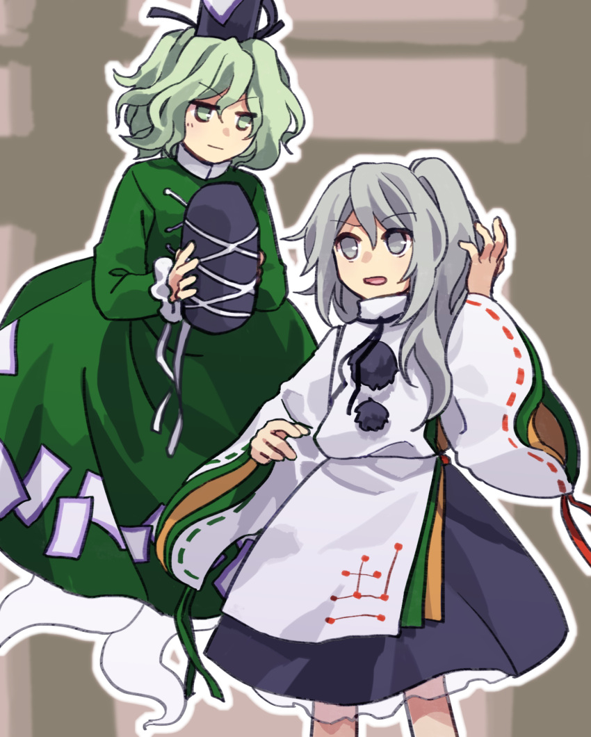 2girls arm_up black_headwear black_skirt closed_mouth commentary_request detached_sleeves dress flat_chest frilled_sleeves frills ghost_tail green_dress green_eyes green_hair grey_eyes grey_hair hat highres holding holding_clothes holding_hat japanese_clothes kaigen_1025 kariginu long_hair long_sleeves mononobe_no_futo multiple_girls ofuda ofuda_on_clothes one_side_up open_mouth ribbon-trimmed_sleeves ribbon_trim short_hair skirt soga_no_tojiko tate_eboshi touhou v-shaped_eyebrows wavy_hair white_sleeves wide_sleeves