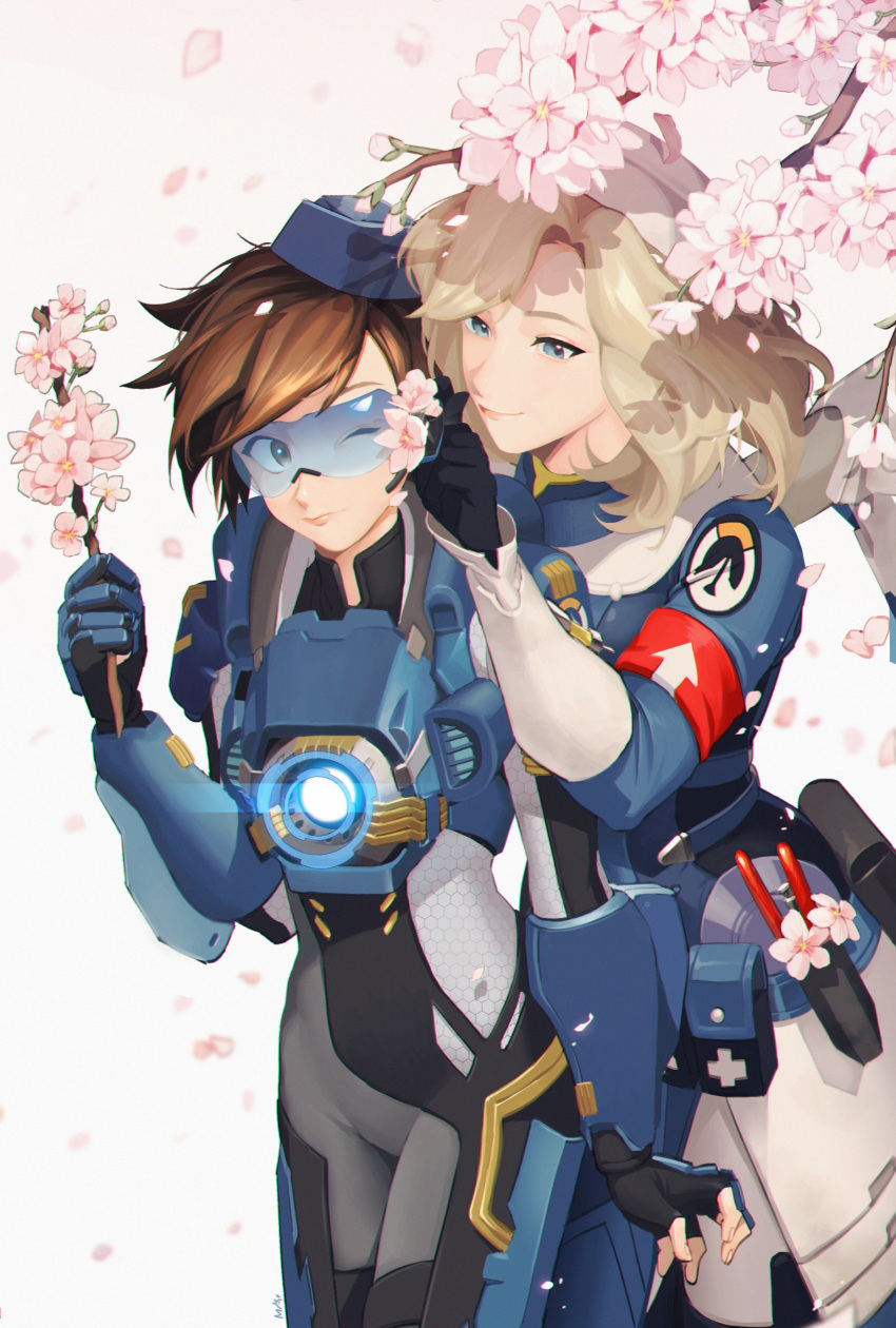 2girls absurdres alternate_costume bangs black_gloves blonde_hair blue_eyes blue_headwear blush bodysuit breasts brown_hair cadet_oxton cherry_blossoms closed_eyes closed_mouth combat_medic_ziegler commentary commentary_request cross fingerless_gloves flower gloves goggles harness hat highres holding holding_stick korean_commentary lips logo long_sleeves looking_at_another maro_(lij512) mechanical_wings mercy_(overwatch) multiple_girls overwatch parted_lips short_hair smile spiked_hair standing tracer_(overwatch) wings