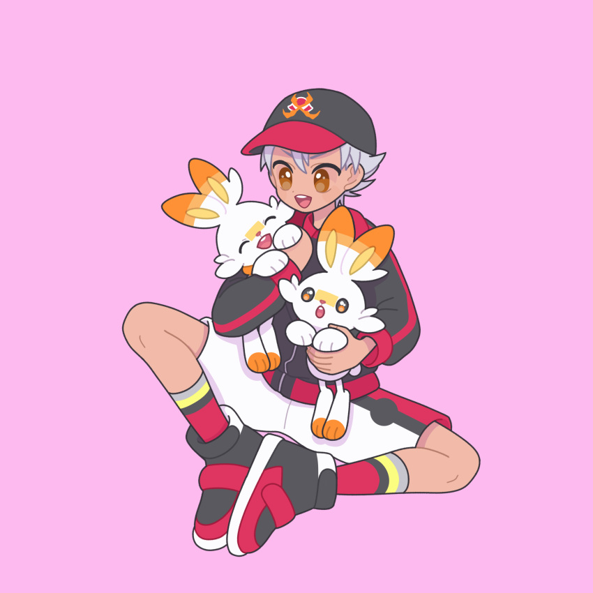 1boy :d baseball_cap black_footwear black_hat black_jacket brown_eyes commentary_request crossover dark-skinned_male dark_skin full_body grey_hair hat highres holding holding_pokemon jacket king_of_prism long_sleeves male_focus nishina_kazuki nyaasechan open_mouth pink_background pokemon pokemon_(creature) pretty_rhythm pretty_series scorbunny shoes short_hair shorts simple_background sitting smile socks white_shorts