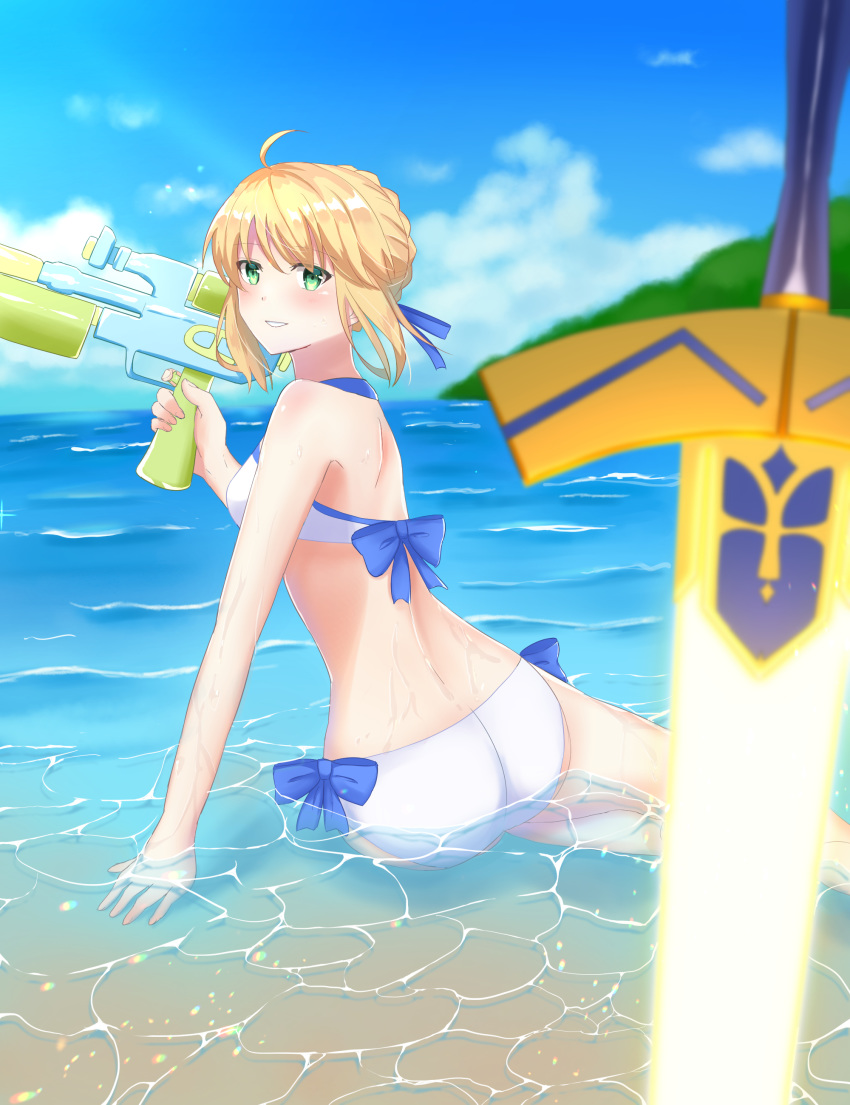 1girl absurdres ahoge arm_support artoria_pendragon_(all) artoria_pendragon_(swimsuit_archer) ass bikini blonde_hair blue_ribbon blue_sky blurry cloud depth_of_field excalibur fate/grand_order fate_(series) green_eyes highres horizon ocean partially_submerged ribbon sand side-tie_bikini sii_artatm sky solo swimsuit water water_gun waves white_bikini