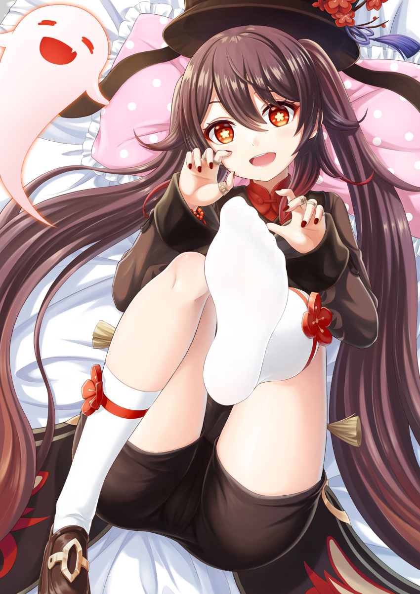 1girl bed_sheet black_shorts brown_hair feet foot_focus genshin_impact ghost hat highres hu_tao jewelry legs long_hair lying nail_polish no_shoes on_back open_mouth pillow red_eyes ring shorts smile socks soles solo symbol-shaped_pupils twintails very_long_hair zzt_(zztsama)