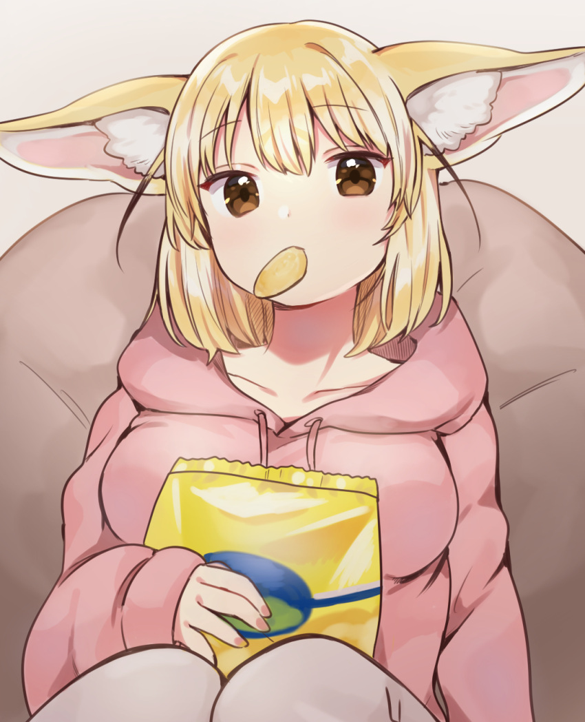 1girl animal_ear_fluff animal_ears bag bangs bean_bag_chair blonde_hair breasts brown_eyes chips collarbone commentary_request eating eyebrows_visible_through_hair fennec_(kemono_friends) food fox_ears gradient gradient_background grey_background highres holding holding_bag hood hoodie kemono_friends knees knees_up light_blush looking_at_viewer medium_breasts medium_hair mouth_hold pink_hoodie simple_background sitting solo suicchonsuisui upper_body